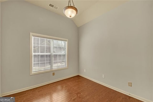206 Glens Loop, Woodstock, GA 30188 - empty room featuring wood finished floors and vaulted ceiling
