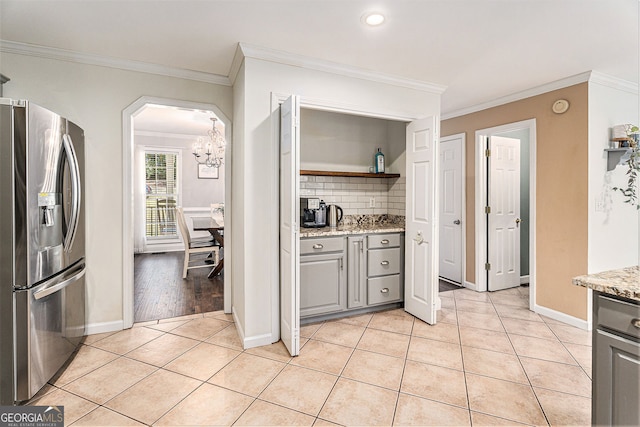 60 Bartlett Way, Dallas, GA 30157 - kitchen with stainless steel fridge, gray cabinetry, a chandelier, light tile patterned floors, and crown molding