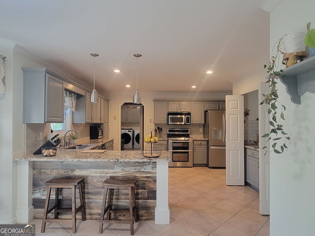 60 Bartlett Way, Dallas, GA 30157 - kitchen featuring appliances with stainless steel finishes, separate washer and dryer, a sink, a peninsula, and gray cabinets