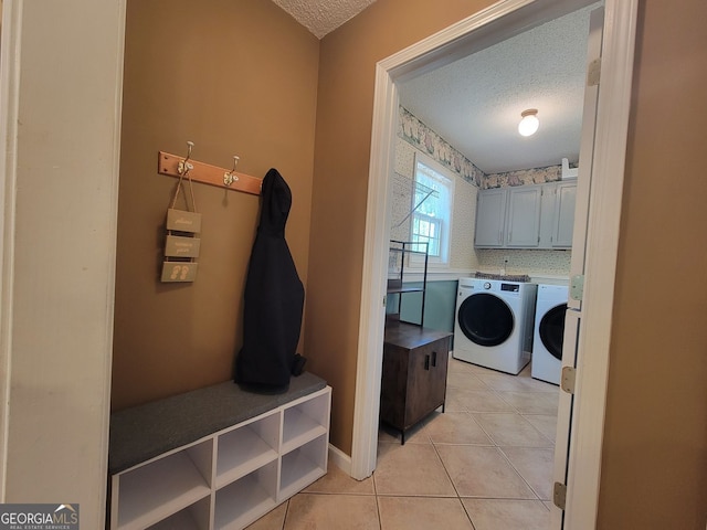 60 Bartlett Way, Dallas, GA 30157 - clothes washing area featuring a textured ceiling, washer and clothes dryer, cabinet space, light tile patterned floors, and baseboards