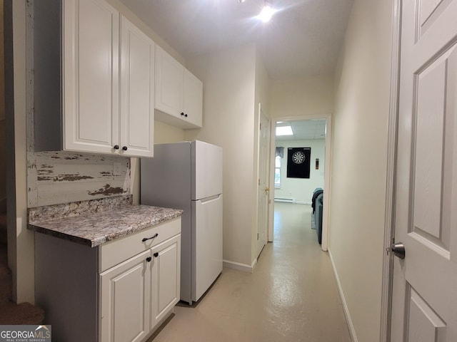 60 Bartlett Way, Dallas, GA 30157 - kitchen with freestanding refrigerator, white cabinetry, baseboards, concrete floors, and a baseboard heating unit