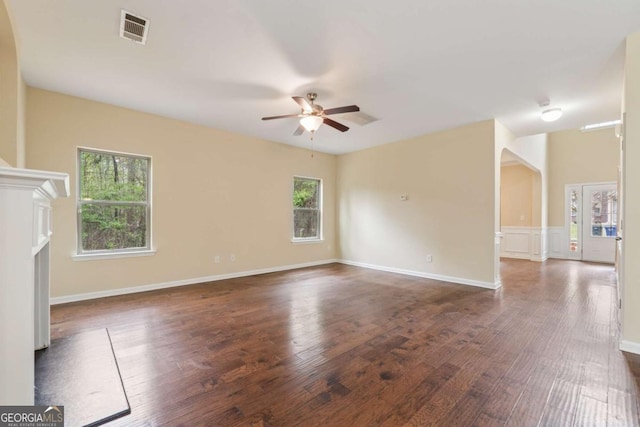 3892 Trillium Wood Trl, Snellville, GA 30039 - unfurnished living room featuring plenty of natural light, a ceiling fan, dark wood-type flooring, and a fireplace