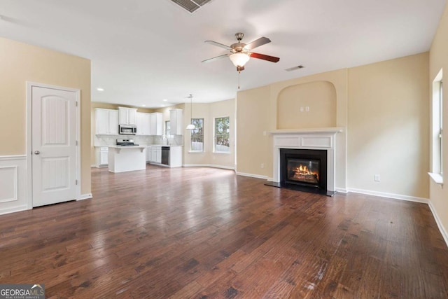 3892 Trillium Wood Trl, Snellville, GA 30039 - unfurnished living room featuring ceiling fan, dark wood-type flooring, a glass covered fireplace, and recessed lighting