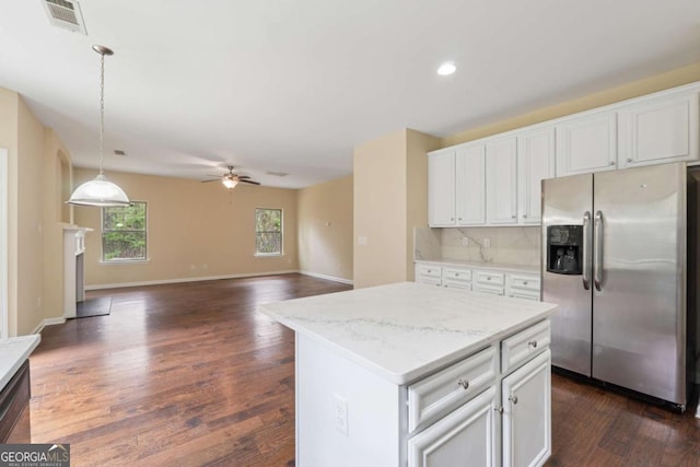 3892 Trillium Wood Trl, Snellville, GA 30039 - kitchen with stainless steel refrigerator with ice dispenser, a ceiling fan, dark wood finished floors, white cabinetry, and pendant lighting