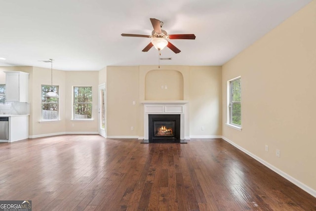 3892 Trillium Wood Trl, Snellville, GA 30039 - unfurnished living room featuring healthy amount of natural light, ceiling fan, a fireplace with flush hearth, and dark wood-style floors