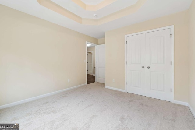 3892 Trillium Wood Trl, Snellville, GA 30039 - unfurnished bedroom with carpet, a closet, and a raised ceiling