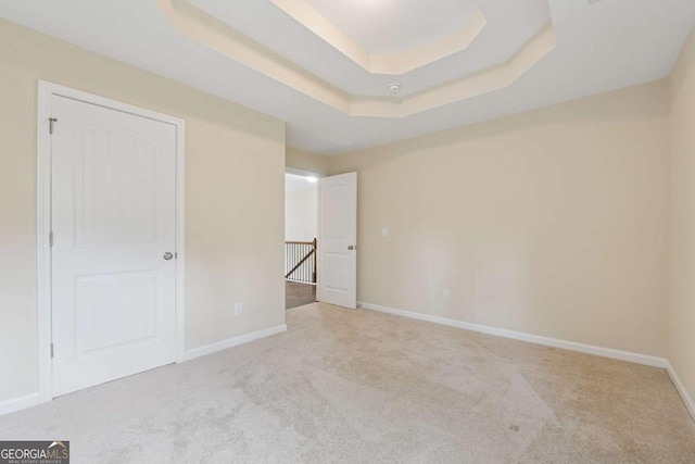 3892 Trillium Wood Trl, Snellville, GA 30039 - unfurnished bedroom with carpet floors and a tray ceiling