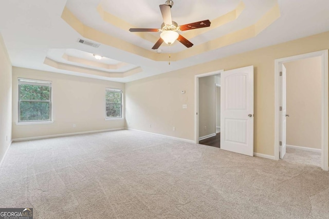 3892 Trillium Wood Trl, Snellville, GA 30039 - unfurnished bedroom with a raised ceiling, carpet floors, multiple windows, and ceiling fan