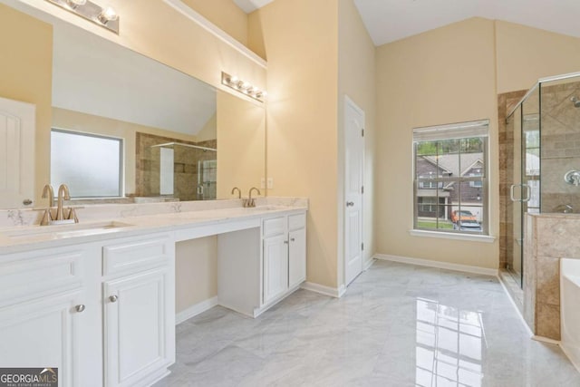 3892 Trillium Wood Trl, Snellville, GA 30039 - full bathroom featuring double vanity, vaulted ceiling, a shower stall, marble finish flooring, and a tub