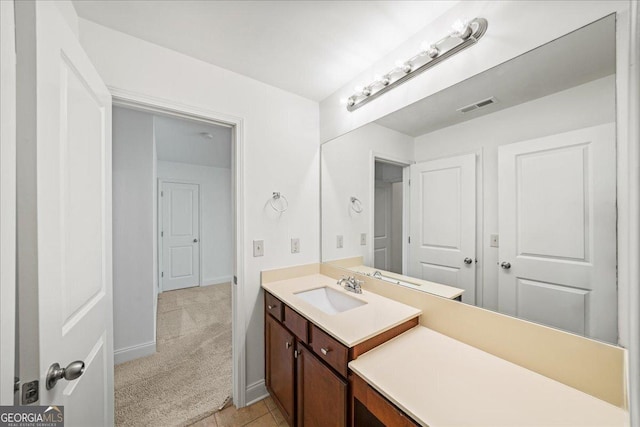 bathroom featuring baseboards, visible vents, and vanity