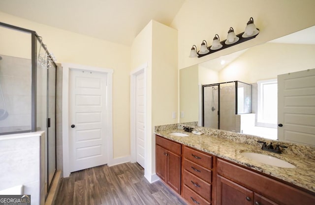 393 Old Good Hope Rd, Good Hope, GA 30641 - full bathroom with double vanity, vaulted ceiling, a stall shower, a sink, and wood finished floors