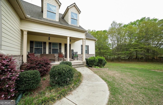 393 Old Good Hope Rd, Good Hope, GA 30641 - doorway to property with a yard, a shingled roof, brick siding, and covered porch