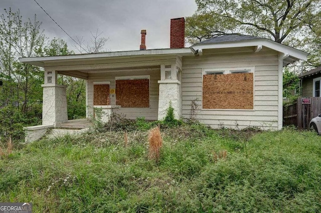 view of front facade featuring a chimney