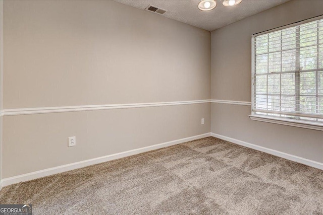 3612 River Mill Ct, Ellenwood, GA 30294 - empty room featuring a textured ceiling, carpet flooring, baseboards, and visible vents
