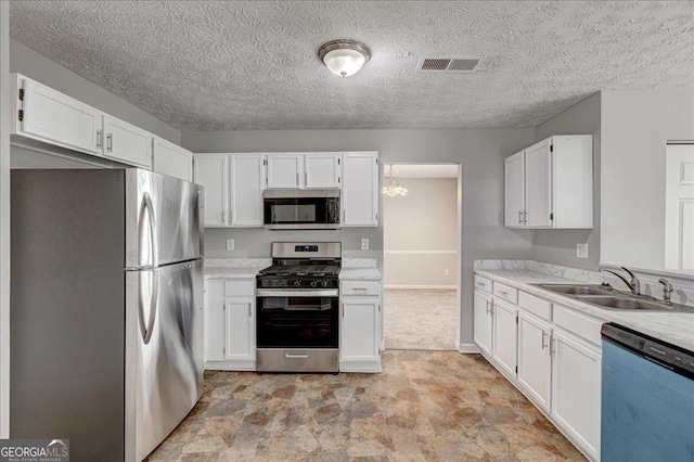 3612 River Mill Ct, Ellenwood, GA 30294 - kitchen featuring white cabinets, visible vents, appliances with stainless steel finishes, light countertops, and a sink