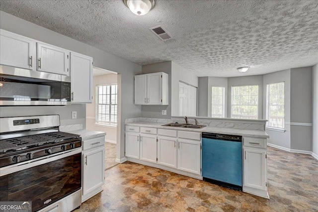3612 River Mill Ct, Ellenwood, GA 30294 - kitchen with visible vents, white cabinets, baseboards, a peninsula, and stainless steel appliances