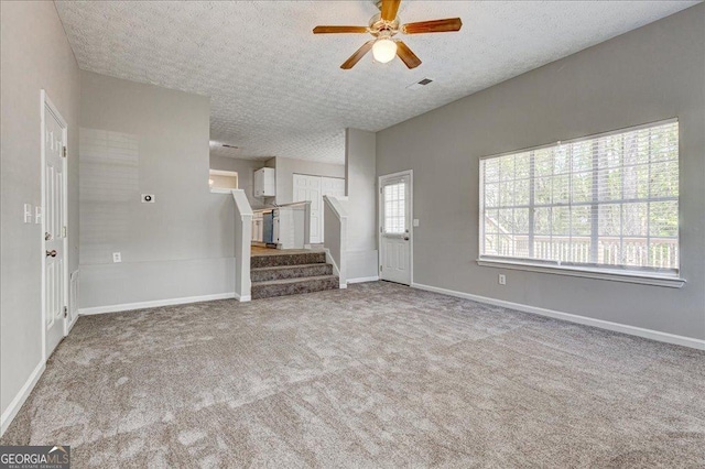 3612 River Mill Ct, Ellenwood, GA 30294 - unfurnished living room featuring carpet floors, a textured ceiling, stairway, and a ceiling fan