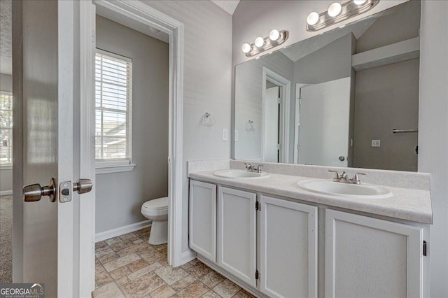 3612 River Mill Ct, Ellenwood, GA 30294 - full bath featuring toilet, stone finish floor, a sink, and baseboards