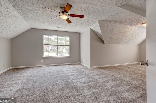 3612 River Mill Ct, Ellenwood, GA 30294 - bonus room with baseboards, ceiling fan, a textured ceiling, vaulted ceiling, and carpet flooring