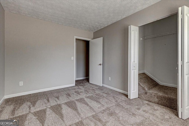 3612 River Mill Ct, Ellenwood, GA 30294 - unfurnished bedroom with a closet, carpet, baseboards, and a textured ceiling