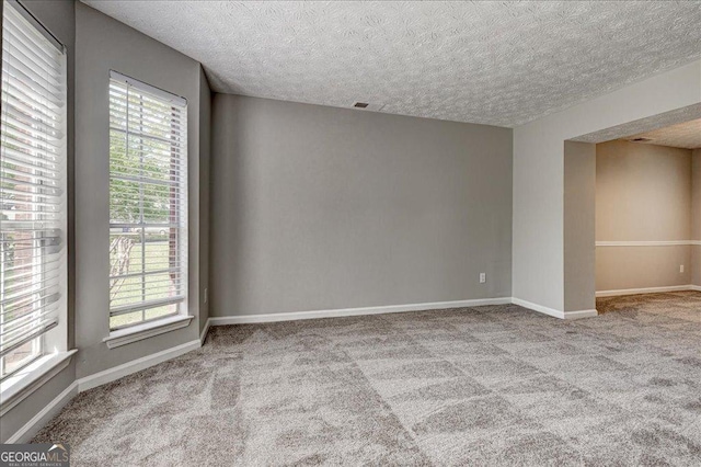 3612 River Mill Ct, Ellenwood, GA 30294 - carpeted spare room with a textured ceiling, baseboards, and visible vents
