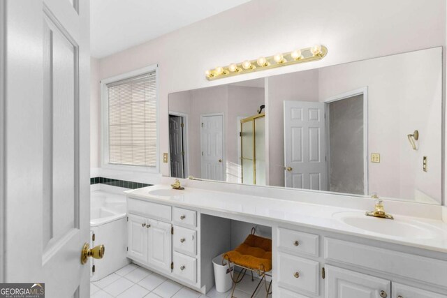 full bathroom with a sink, a shower stall, double vanity, and tile patterned flooring