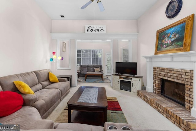 carpeted living area featuring a fireplace, a ceiling fan, and visible vents
