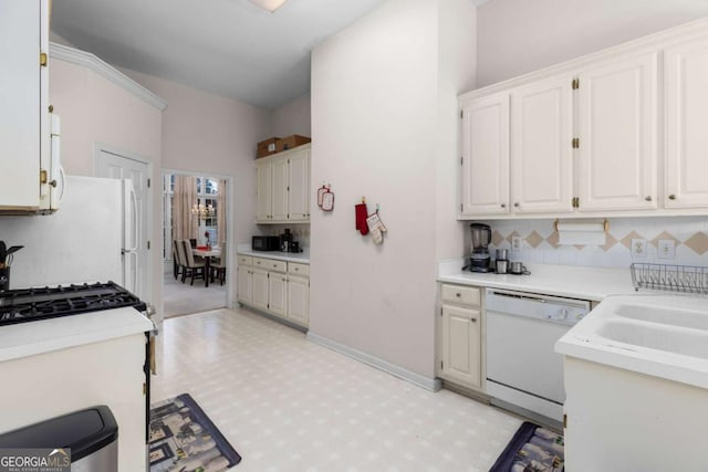 kitchen featuring baseboards, white appliances, light countertops, white cabinetry, and light floors