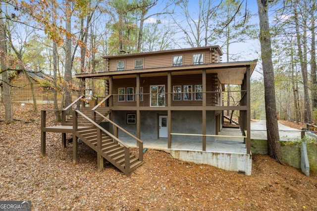 155 Indian Bend Dr, Lagrange, GA 30240 - rear view of house with log exterior, a patio area, a wooden deck, and stairs