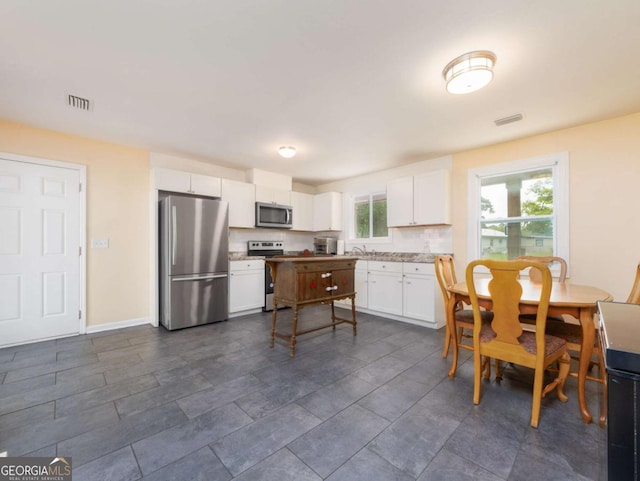 244 Sherwood Ln, Brunswick, GA 31525 - kitchen featuring appliances with stainless steel finishes and white cabinets
