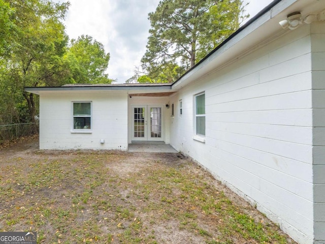244 Sherwood Ln, Brunswick, GA 31525 - rear view of house with french doors and concrete block siding