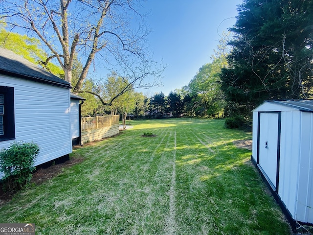 view of yard with an outdoor structure and a shed