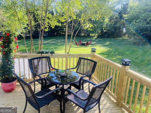 wooden terrace featuring a yard