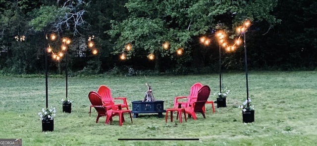 surrounding community with a lawn and a fire pit