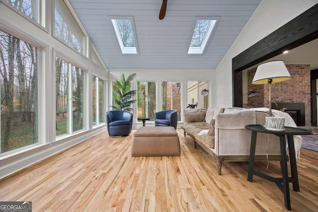 2433 Helmsdale Dr NE, Atlanta, GA 30345 - sunroom / solarium featuring a skylight, wood finished floors, high vaulted ceiling, and a deck