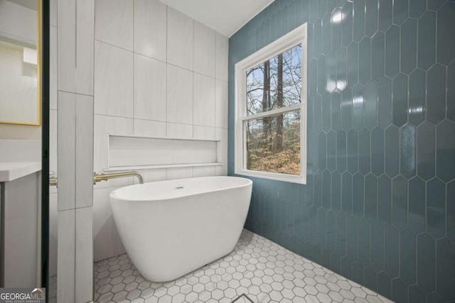 2433 Helmsdale Dr NE, Atlanta, GA 30345 - bathroom featuring tile walls and a freestanding tub