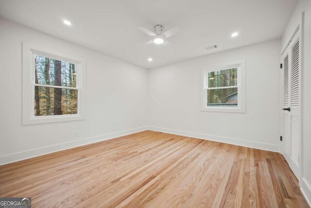 2433 Helmsdale Dr NE, Atlanta, GA 30345 - unfurnished bedroom featuring light wood-type flooring, baseboards, multiple windows, and visible vents