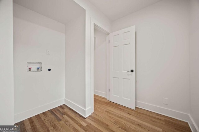 2433 Helmsdale Dr NE, Atlanta, GA 30345 - washroom featuring light wood-style flooring, electric dryer hookup, hookup for a washing machine, and baseboards