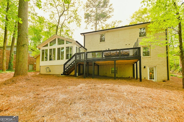 2433 Helmsdale Dr NE, Atlanta, GA 30345 - rear view of house with stairs, brick siding, a deck, and a sunroom