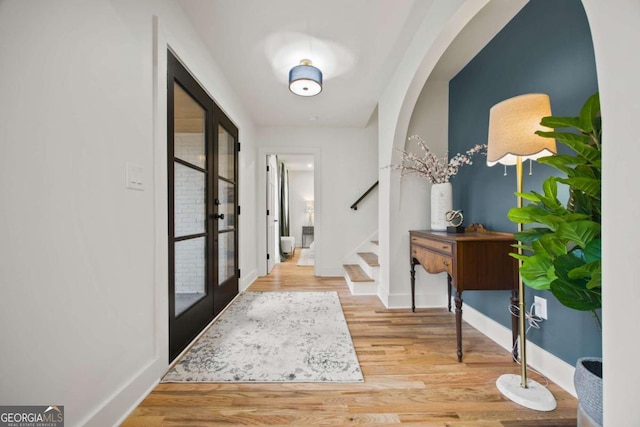 2433 Helmsdale Dr NE, Atlanta, GA 30345 - foyer with french doors, baseboards, stairway, and wood finished floors