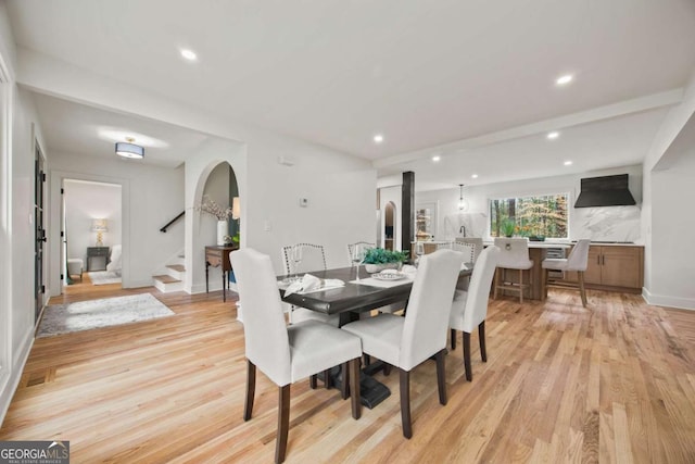 2433 Helmsdale Dr NE, Atlanta, GA 30345 - dining space with recessed lighting, stairway, arched walkways, and light wood-style floors