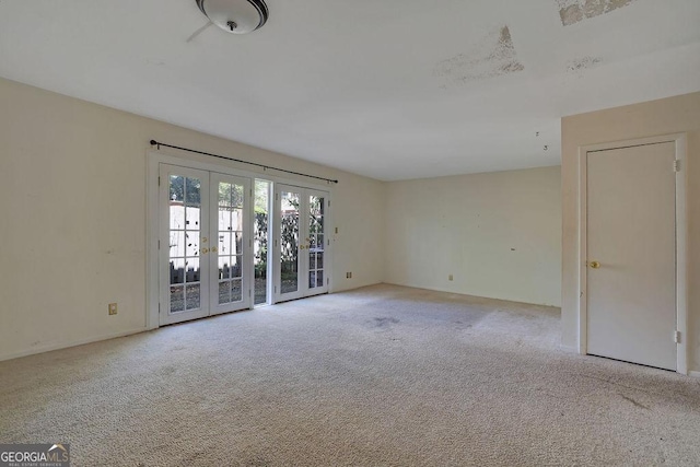 spare room featuring french doors and carpet floors