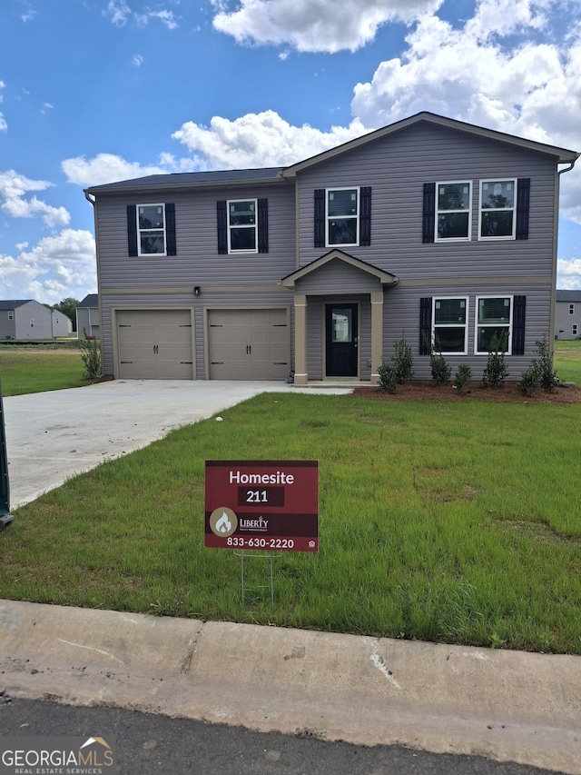 traditional-style home with an attached garage, driveway, and a front lawn