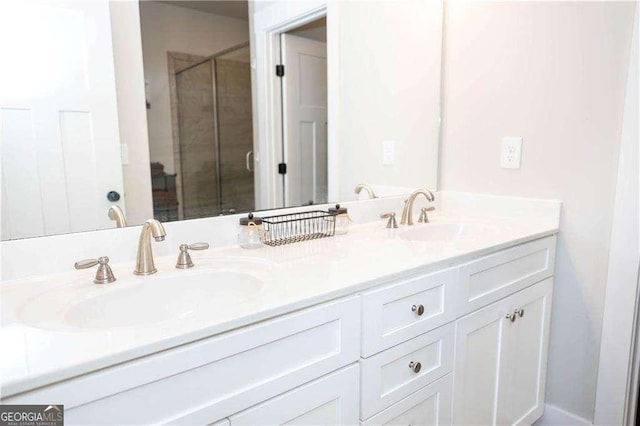 bathroom with double vanity, a sink, and a stall shower