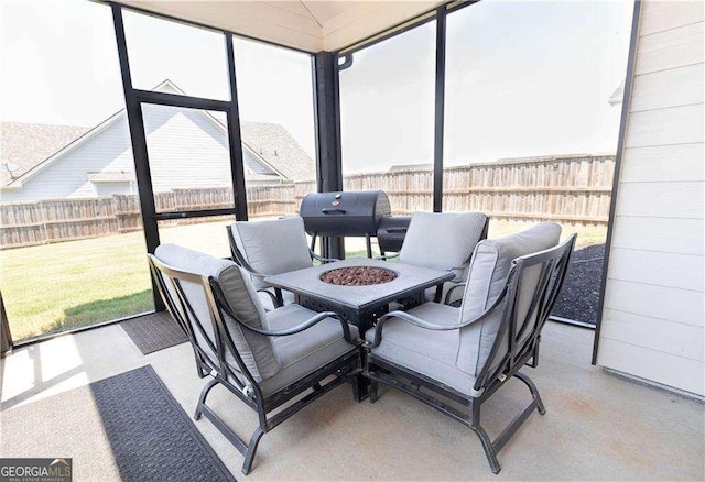 sunroom / solarium featuring an outdoor living space with a fire pit