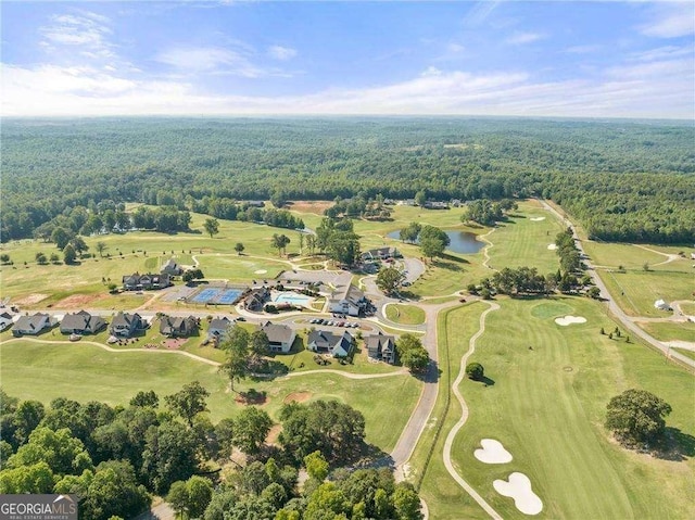 aerial view featuring a wooded view and a water view