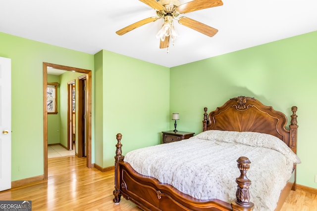 bedroom featuring light wood finished floors, baseboards, and ceiling fan