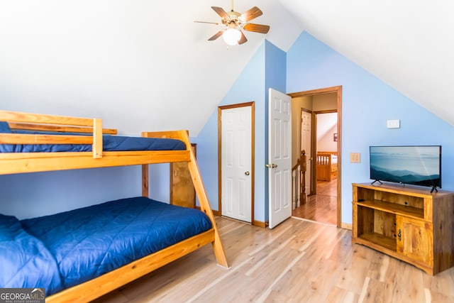 bedroom featuring baseboards, a ceiling fan, wood finished floors, and lofted ceiling
