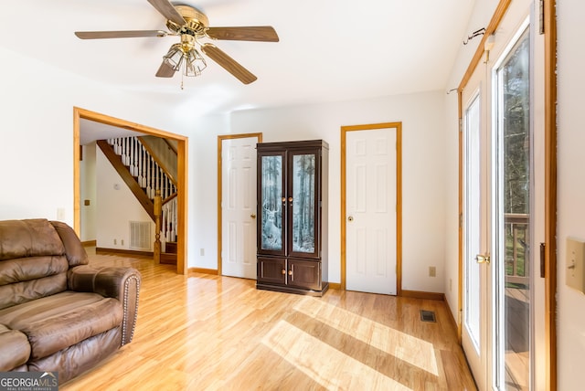 entrance foyer featuring visible vents, a wealth of natural light, light wood-type flooring, and stairs