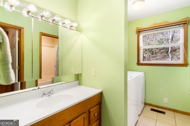 bathroom with visible vents, baseboards, washer and dryer, vanity, and tile patterned flooring
